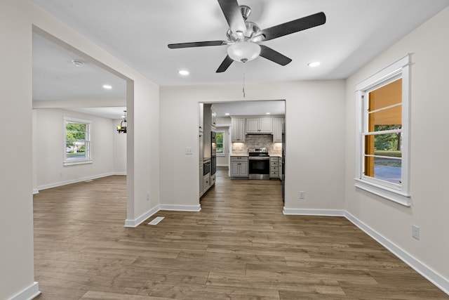 living room with ceiling fan and hardwood / wood-style flooring