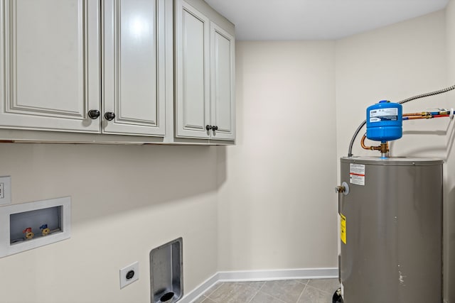 laundry area with electric dryer hookup, washer hookup, electric water heater, light tile patterned flooring, and cabinets