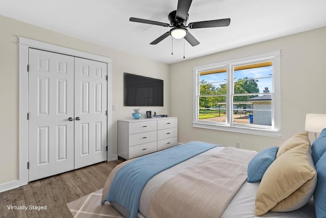 bedroom featuring a closet, light wood-type flooring, and ceiling fan