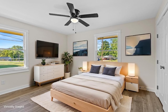 bedroom with a closet, ceiling fan, and hardwood / wood-style floors