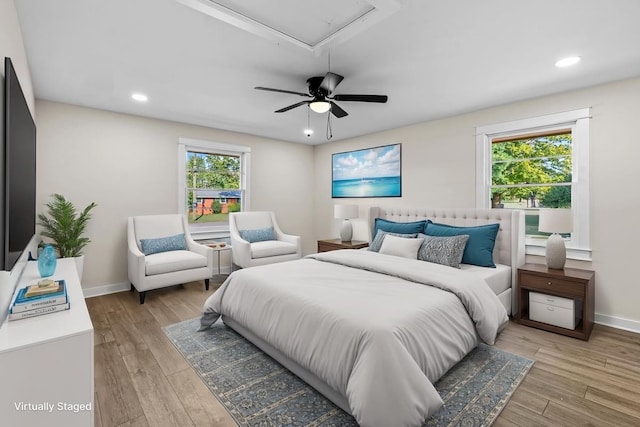 bedroom with light hardwood / wood-style floors and ceiling fan