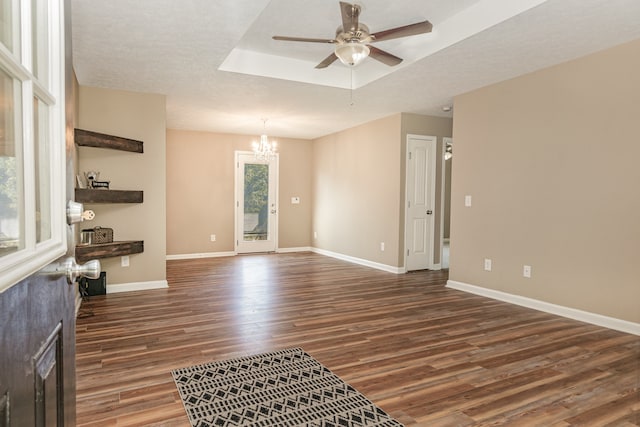 spare room featuring a textured ceiling, ceiling fan with notable chandelier, and dark hardwood / wood-style flooring