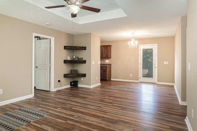 unfurnished living room with dark wood-type flooring, a textured ceiling, and ceiling fan with notable chandelier