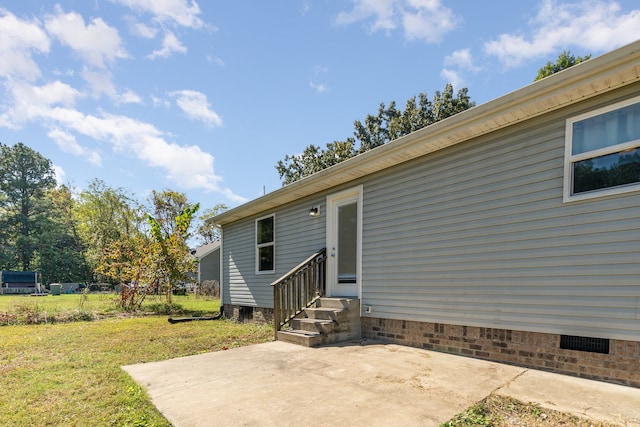 exterior space featuring a patio area and a lawn