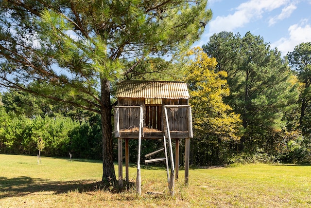 view of outbuilding featuring a lawn