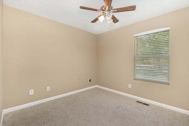 spare room with carpet flooring and ceiling fan