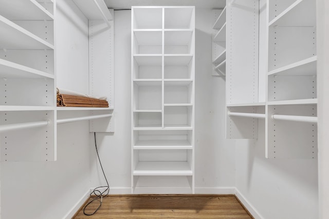 spacious closet featuring hardwood / wood-style floors