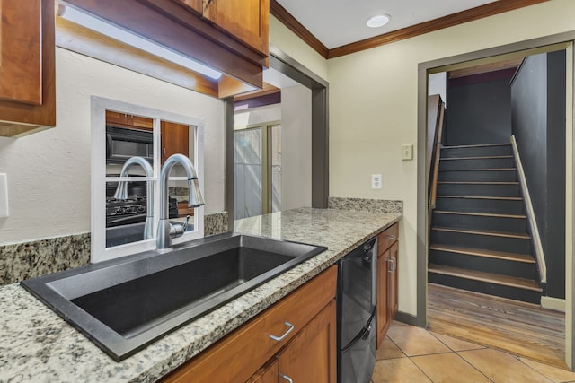 kitchen featuring ornamental molding, black appliances, sink, light tile patterned floors, and light stone counters