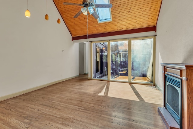 unfurnished living room with wood-type flooring, a skylight, wood ceiling, ceiling fan, and high vaulted ceiling