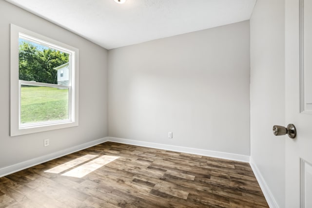 unfurnished room featuring dark hardwood / wood-style flooring