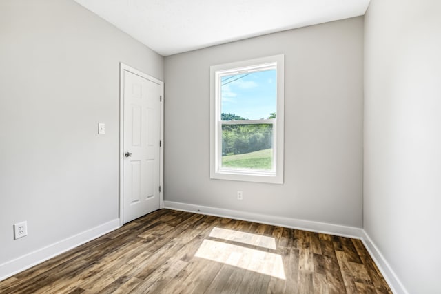 unfurnished room featuring dark hardwood / wood-style floors