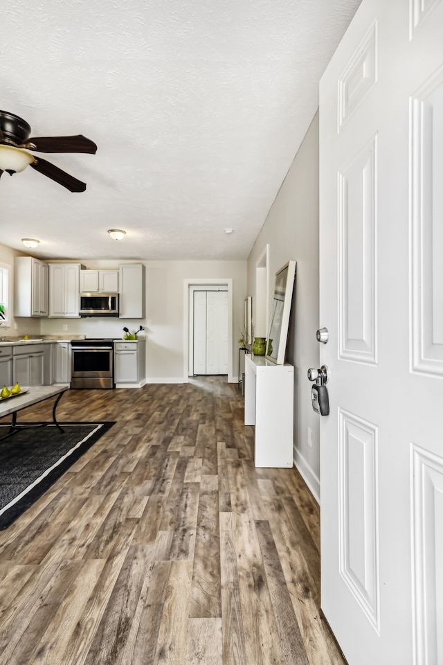 living room featuring wood-type flooring and ceiling fan