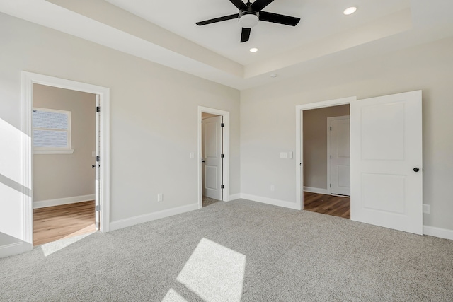 unfurnished bedroom featuring dark colored carpet and ceiling fan