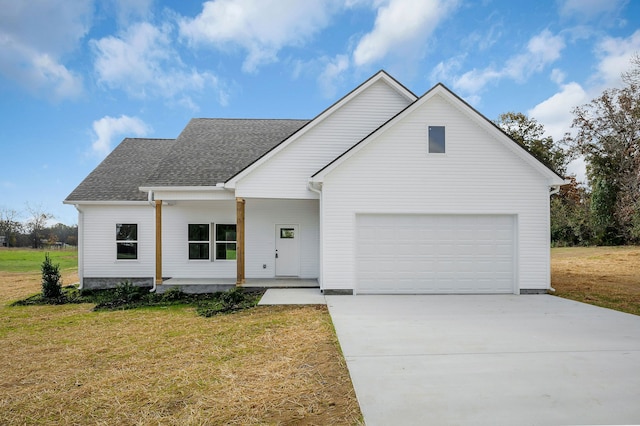 view of front of property with a front lawn and a garage