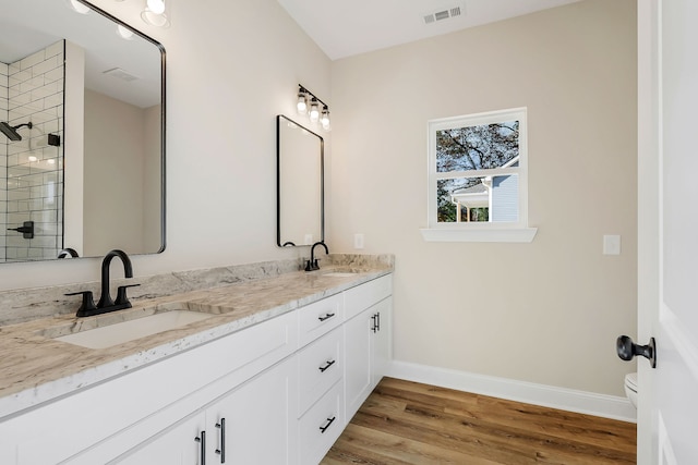 bathroom featuring wood-type flooring, vanity, and toilet