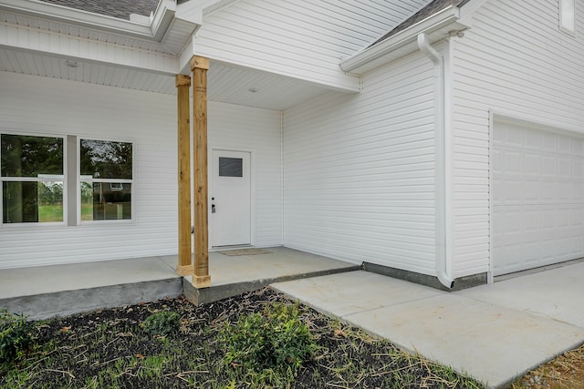 view of exterior entry with a garage