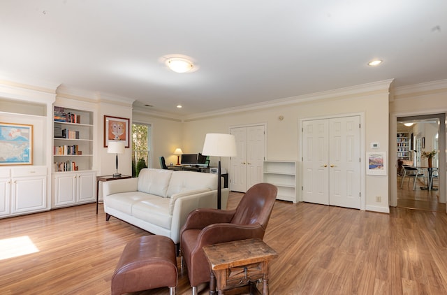 living room featuring ornamental molding and light hardwood / wood-style floors