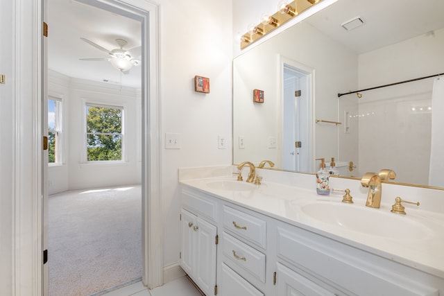 bathroom featuring ceiling fan, walk in shower, and vanity