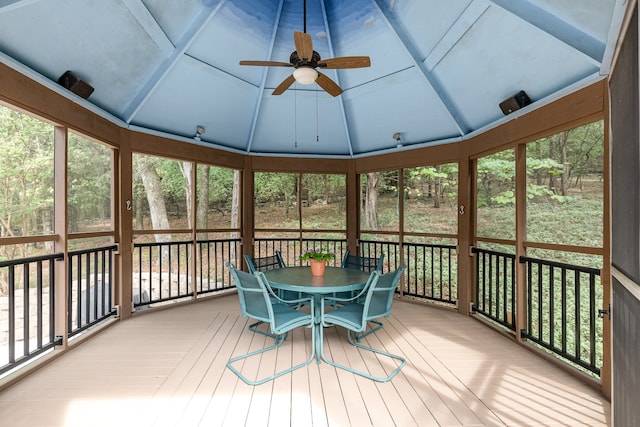 unfurnished sunroom featuring vaulted ceiling and ceiling fan