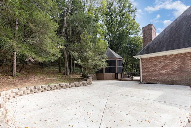 view of patio with a sunroom