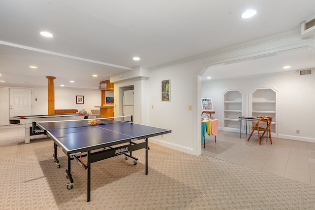 playroom featuring built in shelves, ornamental molding, and light tile patterned floors