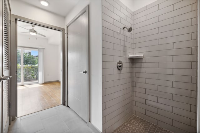 bathroom featuring a tile shower, ceiling fan, and hardwood / wood-style flooring