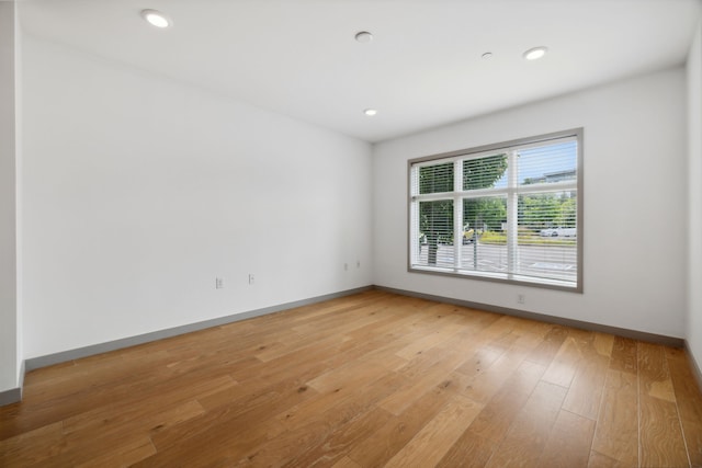 unfurnished room with light hardwood / wood-style floors