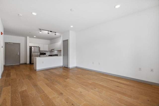 unfurnished living room with light hardwood / wood-style floors