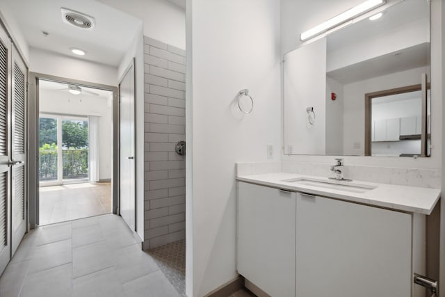 bathroom featuring ceiling fan, vanity, and tile patterned flooring