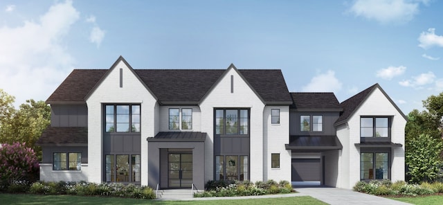 view of front of property with a front yard and a garage