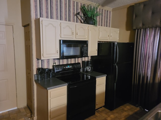 kitchen with white cabinets, black appliances, and a textured ceiling