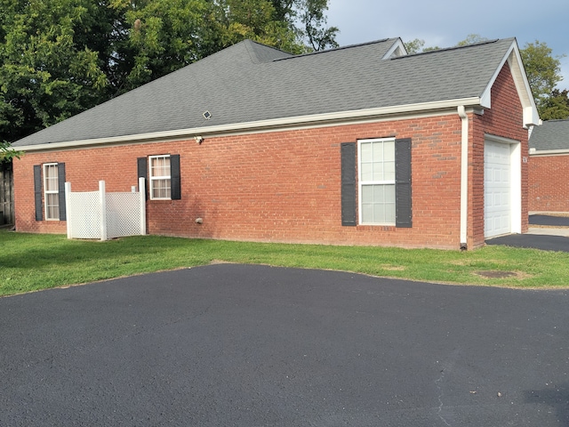 view of home's exterior featuring a yard and a garage