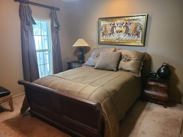 bedroom featuring light carpet