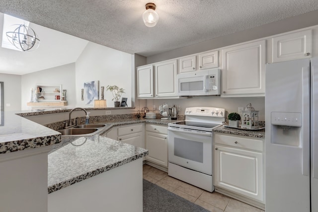 kitchen with white appliances, sink, vaulted ceiling, a textured ceiling, and white cabinetry