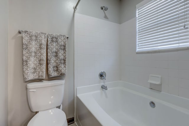 bathroom with toilet and bathtub / shower combination