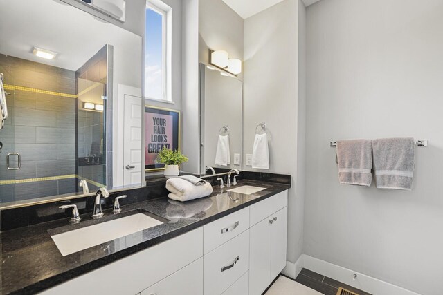 bathroom with vanity and a shower with shower door