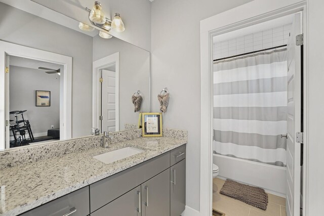 full bathroom with tile patterned flooring, shower / tub combo, ceiling fan, vanity, and toilet