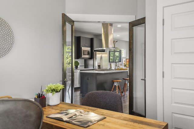 dining space featuring a healthy amount of sunlight and dark hardwood / wood-style flooring