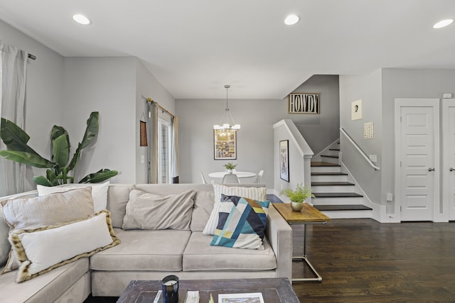 living room featuring a notable chandelier and dark hardwood / wood-style flooring