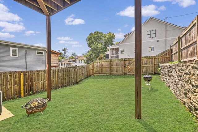 view of yard with a fire pit