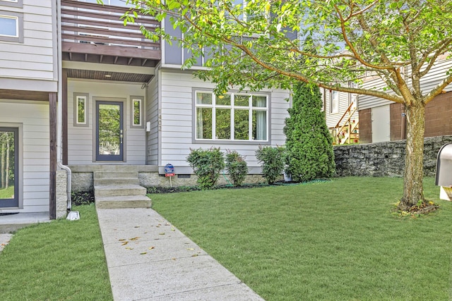 doorway to property with a lawn