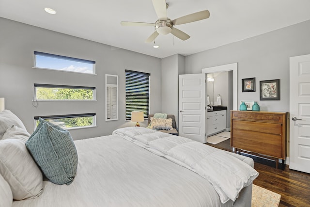 bedroom featuring dark hardwood / wood-style flooring, ceiling fan, and ensuite bathroom