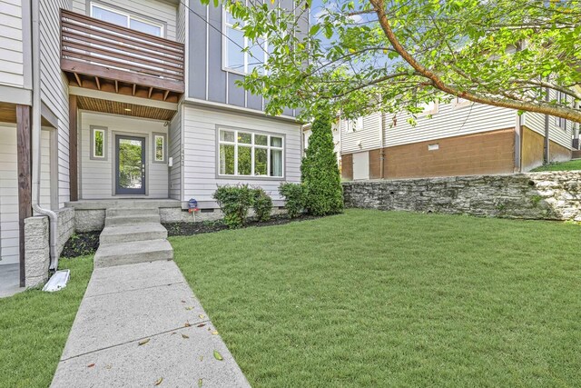 exterior space with a lawn and a balcony