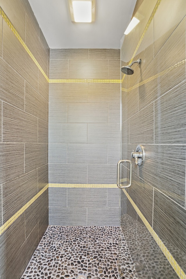 bathroom featuring a shower with door