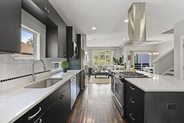 kitchen with island range hood, sink, stainless steel appliances, and a wealth of natural light