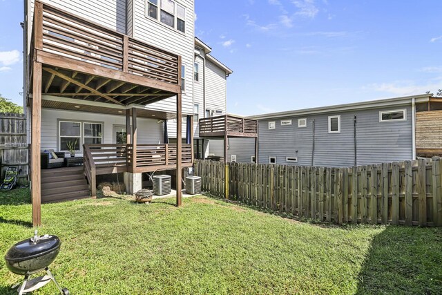 view of yard featuring a deck and central AC unit