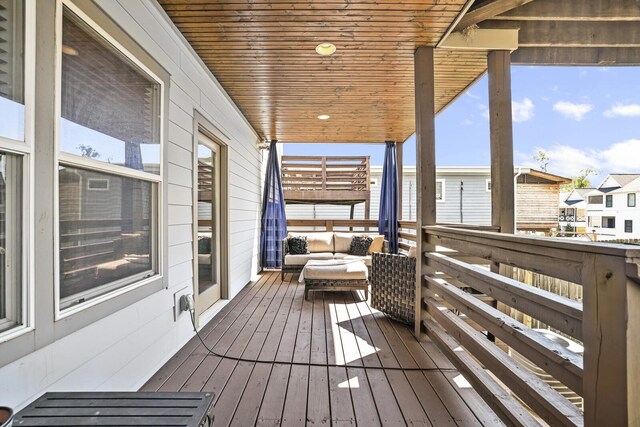 wooden terrace with outdoor lounge area