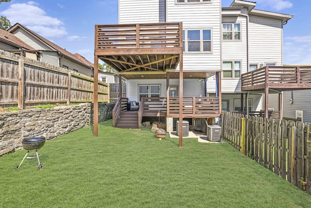 back of property featuring a lawn, cooling unit, and a deck