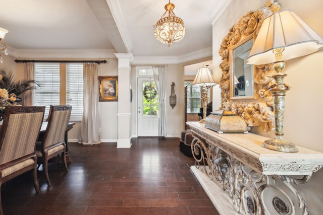 foyer entrance with ornamental molding, decorative columns, and dark wood-type flooring