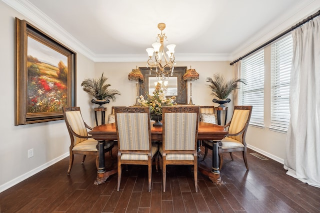 dining area with ornamental molding, a chandelier, and dark wood-type flooring